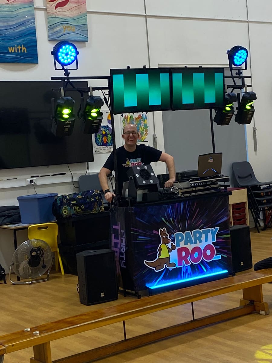 A DJ set up with lights and speakers in the school hall, ready for a disco