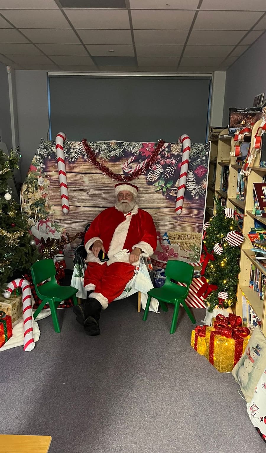 Santa's grotto set up in the school library, with a Christmas tree and presents